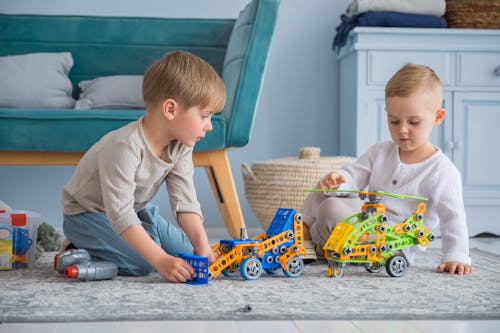 Children Playing With Multi-Color Toy Constructor