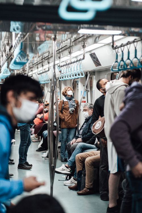 Free Unrecognizable passengers in casual clothes and face masks commuting by subway train  during coronavirus pandemic Stock Photo