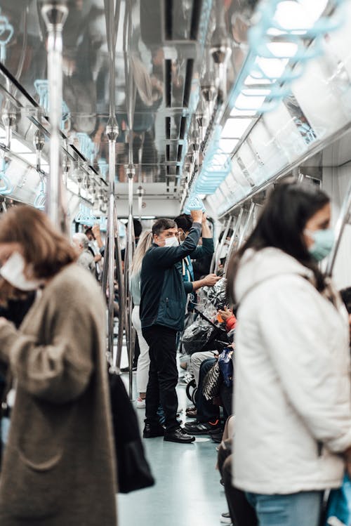Free Unrecognizable passengers riding underground train during coronavirus Stock Photo