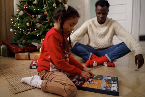 Free Dad and Daughter Playing an Advent Calendar Game Stock Photo