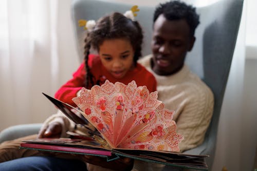 Free Dad and Daughter Reading a Cutouts Fairy Tale Book Stock Photo
