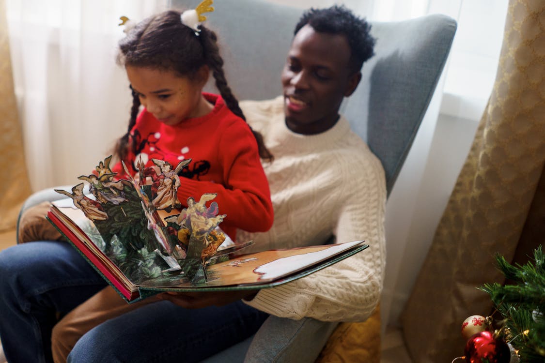 Free Dad and Daughter Having Fun While Reading a Fairy Tale Book Stock Photo