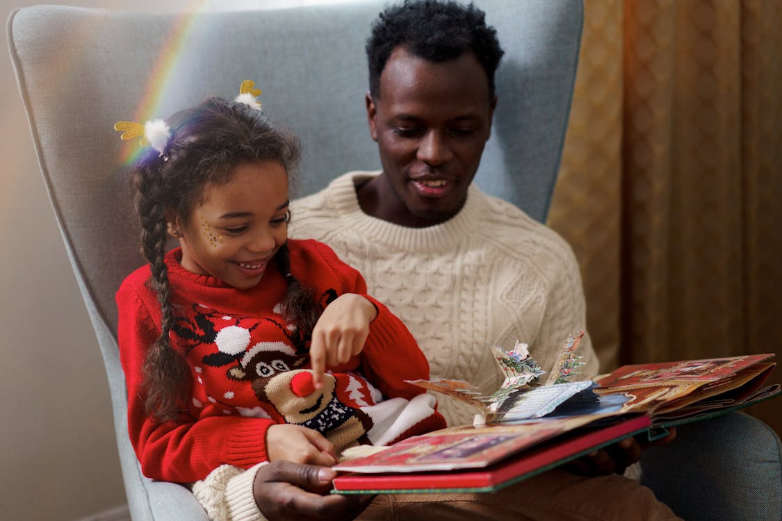 Dad and Daughter Having Fun While Reading a Fairy Tale Book