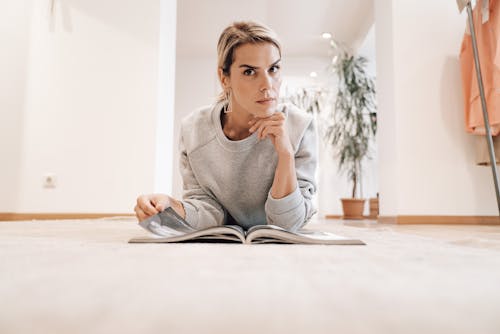 Focused woman reading news in magazine