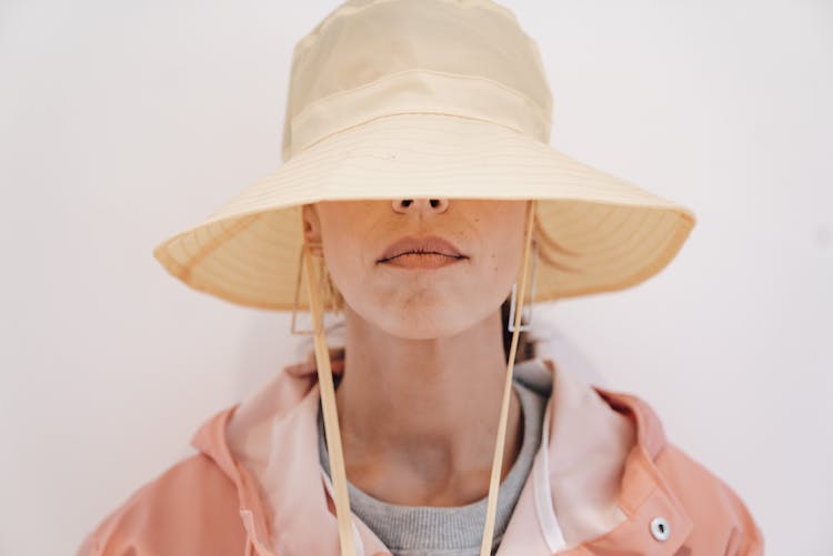 Trendy Woman Hiding Face Behind Hat