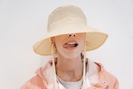 Stylish woman in hat with tongue out