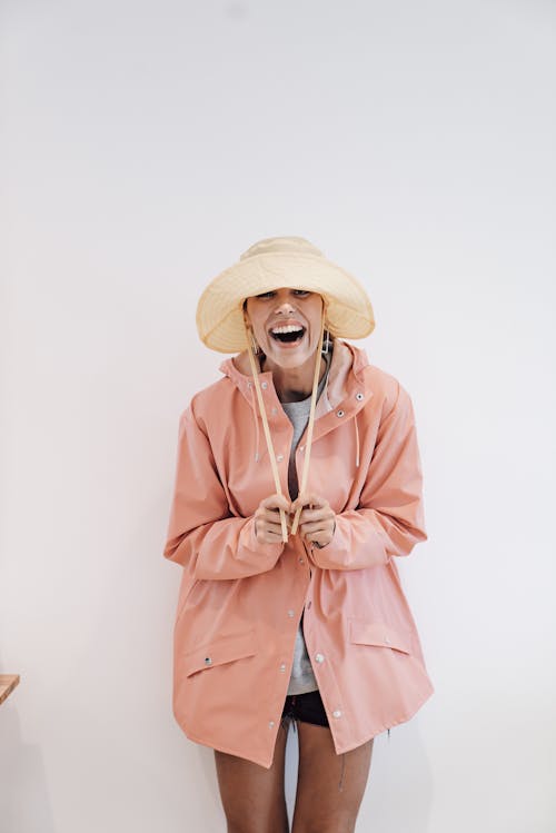 Excited woman in panama hat on white background