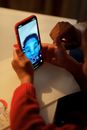 Person Holding and Taking Selfie Using a Smartphone
