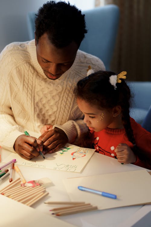 A Girl Watching Her Dad Make a Christmas Letter