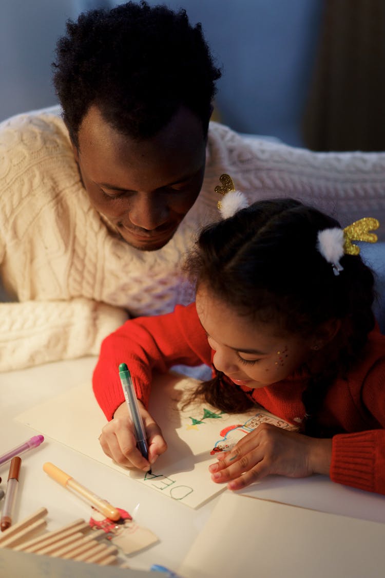 Dad Watching Her Daughter Make A Christmas Letter