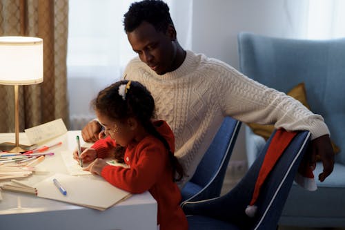 Dad Watching Her Daughter Make a Christmas Letter