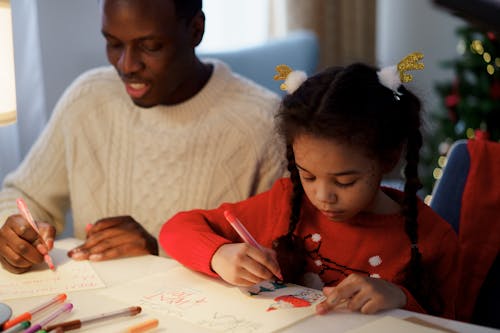 Free Dad and Daughter Making a Christmas Letter Stock Photo