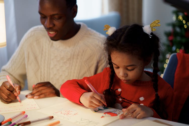 Dad And Daughter Making A Christmas Letter