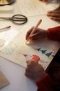 A Person in Red Sweater Making a Christmas Letter