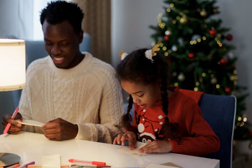 Free Dad and Daughter Making a Christmas Letter Stock Photo