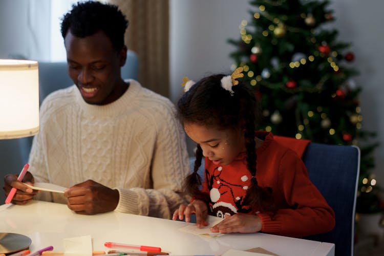 Dad And Daughter Making A Christmas Letter