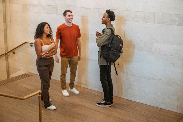 Diverse Friends Speaking In Hallway