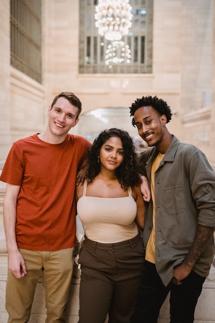 Positive Diverse Friends Hugging And Looking At Camera