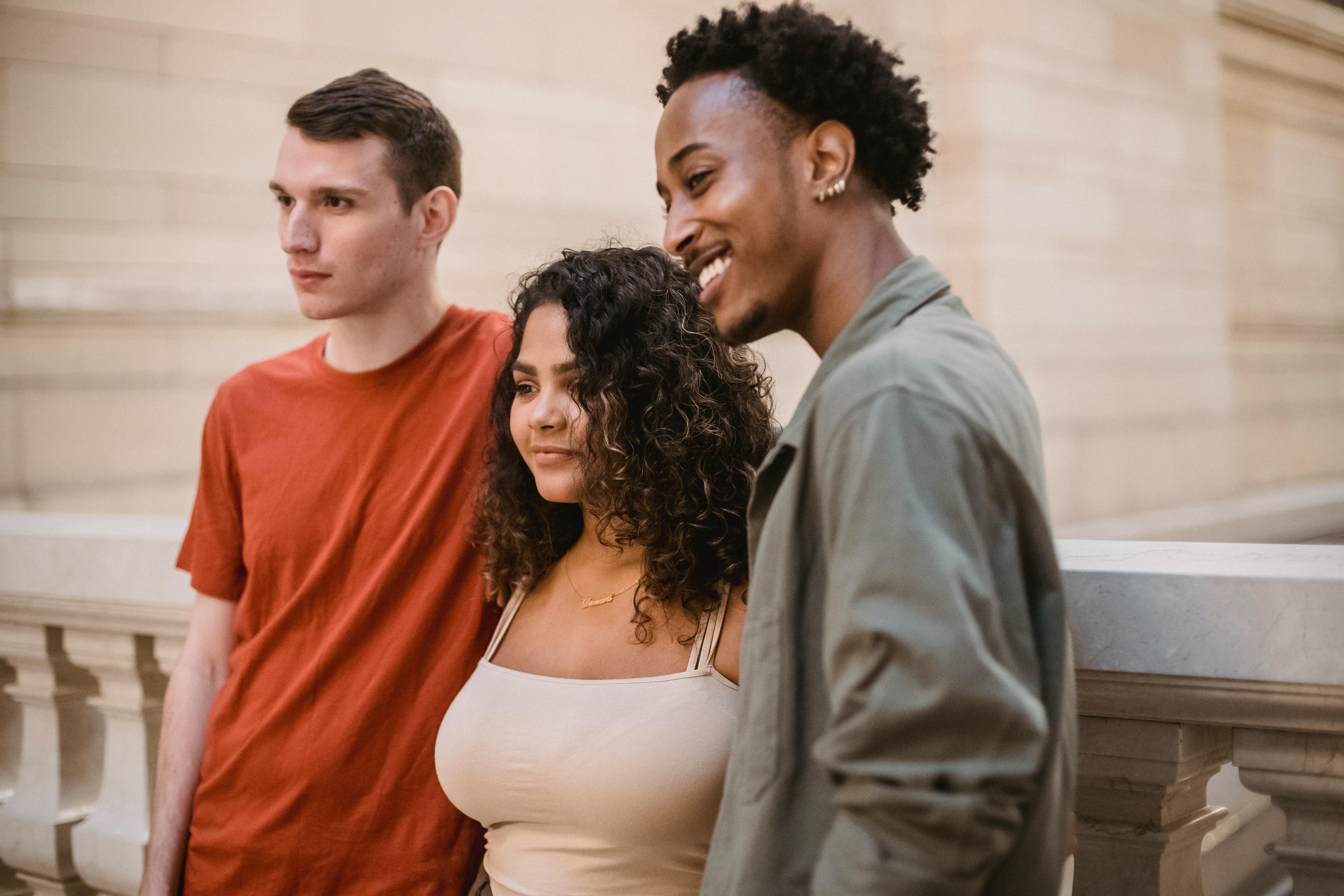 content multiethnic friends standing near fence