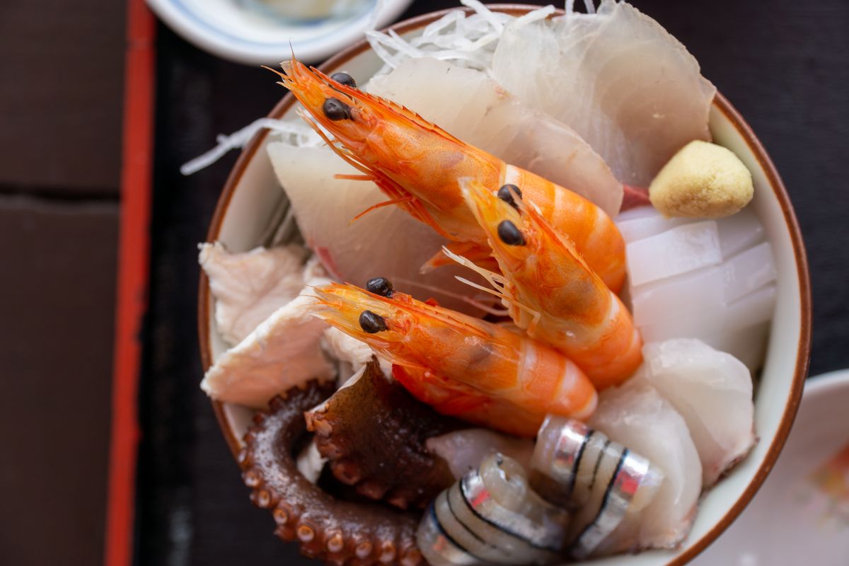 Fresh seafood sashimi served in a bowl, a staple of Okinawa's sea-forward cuisine