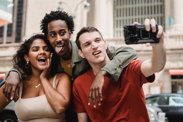 Funny Multiethnic Friends Taking Selfie On Street