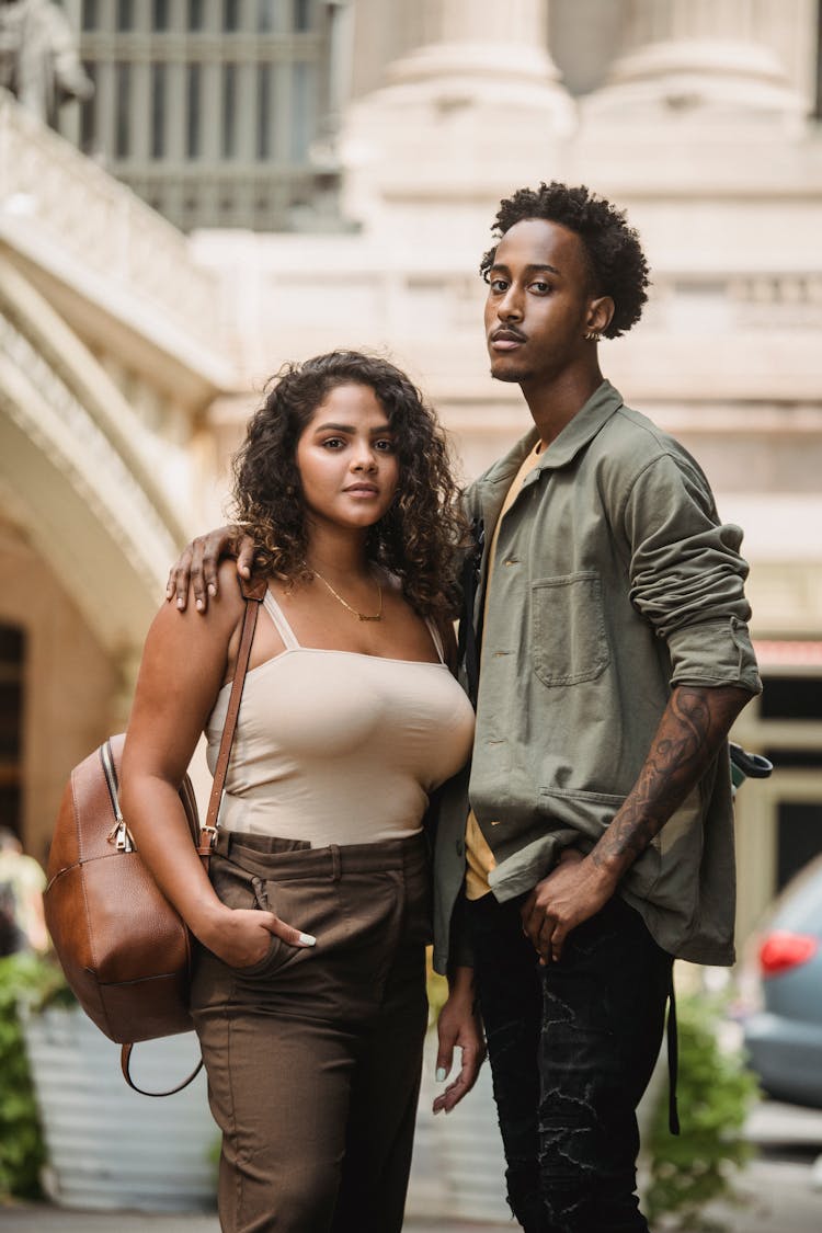 Confident Multiracial Couple Standing On City Street And Looking At Camera