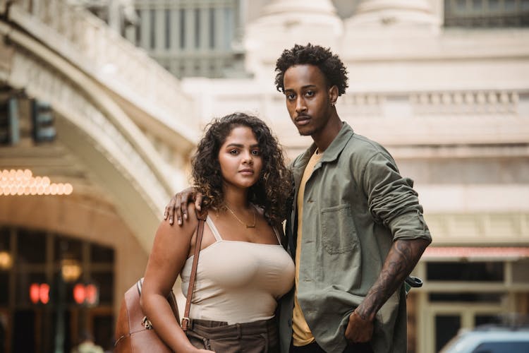 Young Multiethnic Couple Embracing While Standing On Urban Background