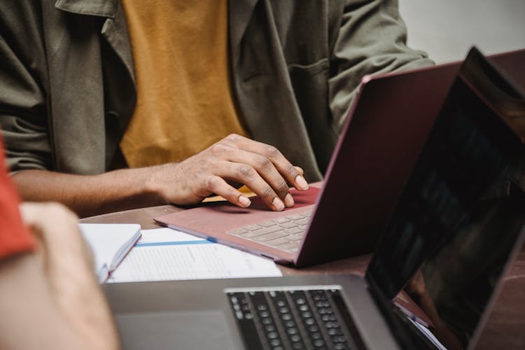 Crop Faceless Diverse Male Colleagues Working On Netbooks In Office