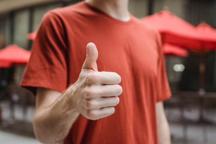 youtube likes thumbs up man in red shirt