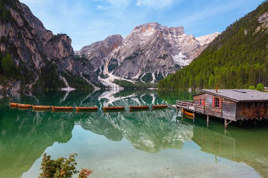 Brown Wooden Boat on Lake Near Mountain