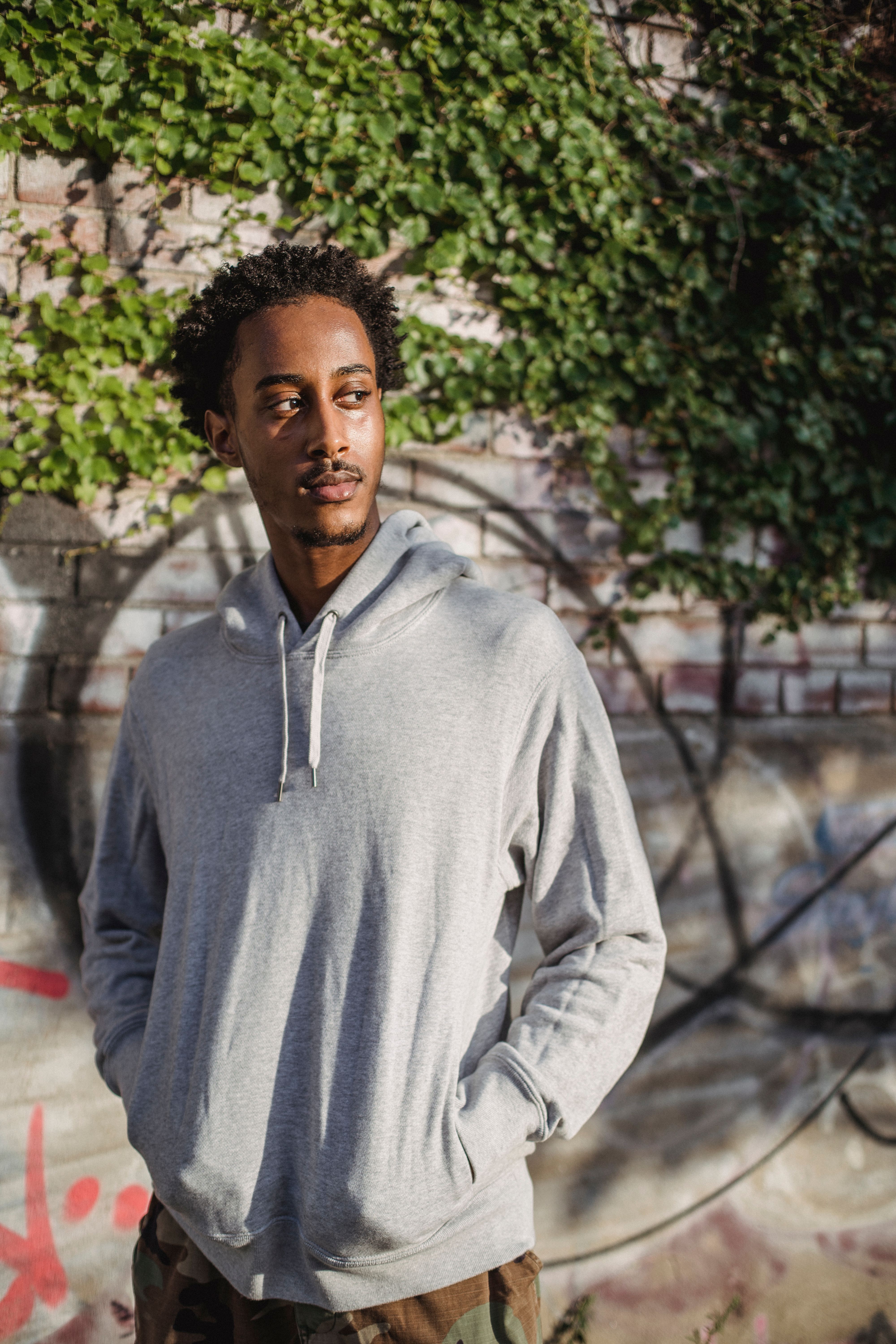 Confident young black man chilling on city street in sunlight · Free ...