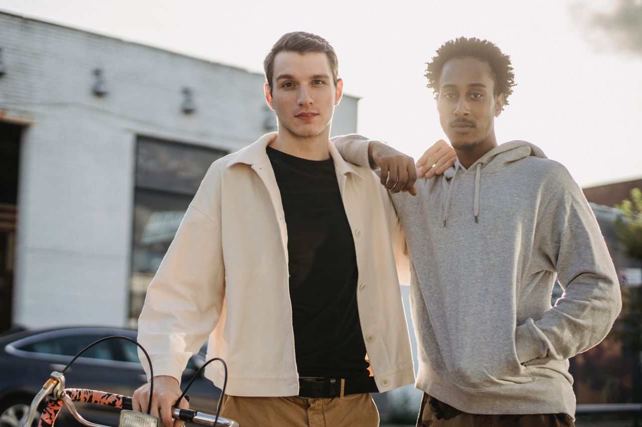 confident young multiethnic male best friends in trendy clothes standi