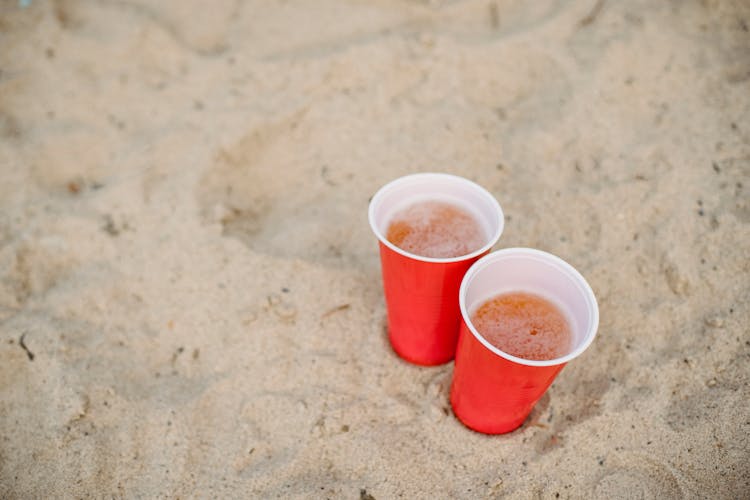 Red Cups With Beer On Sand