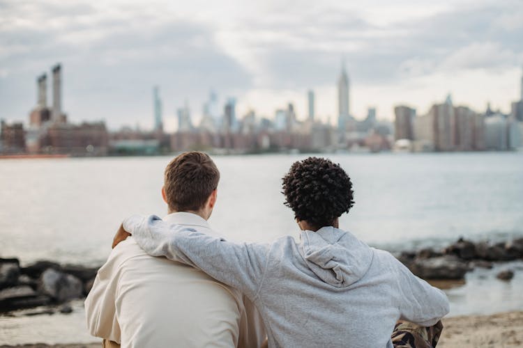 Diverse Best Friends Hugging On Embankment