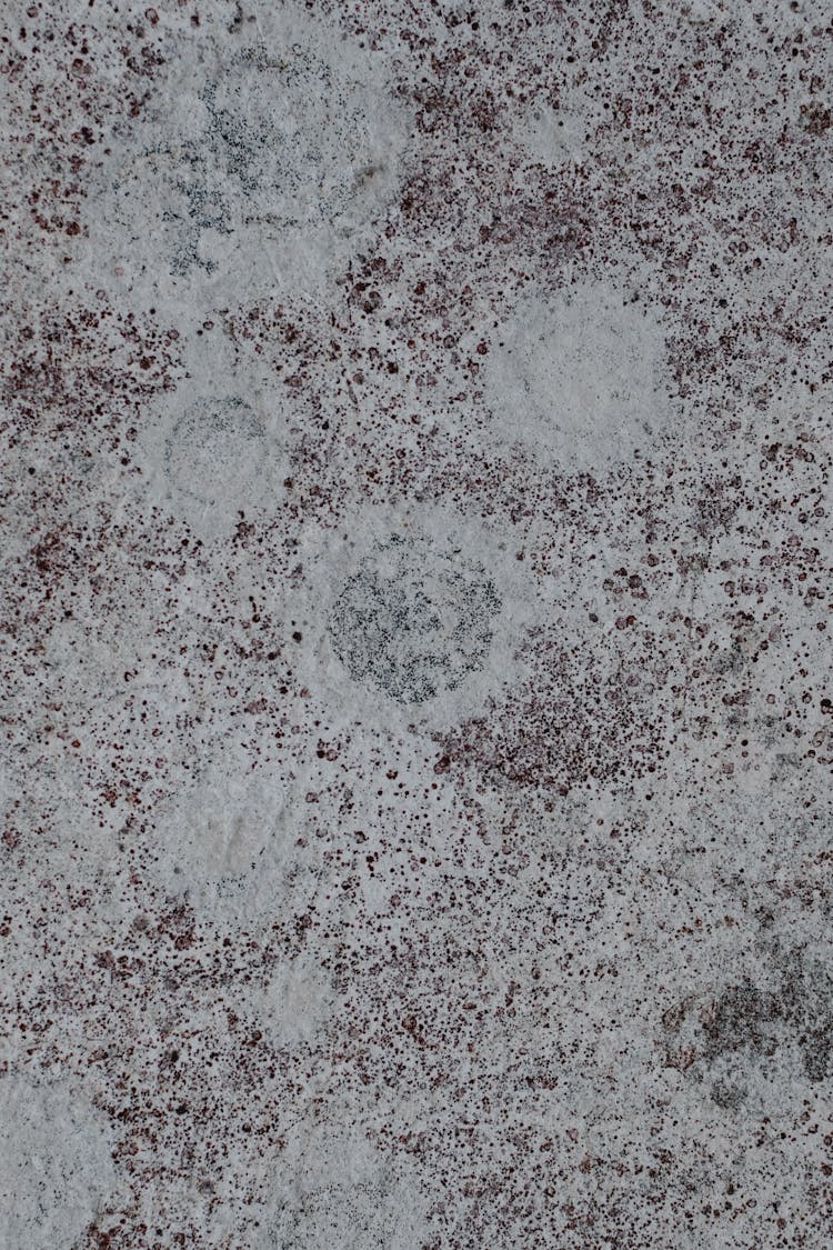 A Concrete Surface With Round Marks