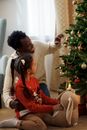 Dad and Daughter Sitting on Floor While Looking at a Christmas Tree