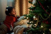 Girl in Red Sweater Lying Down on Pillows