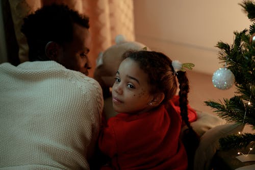 Girl in Red Sweater Lying Beside Her Dad