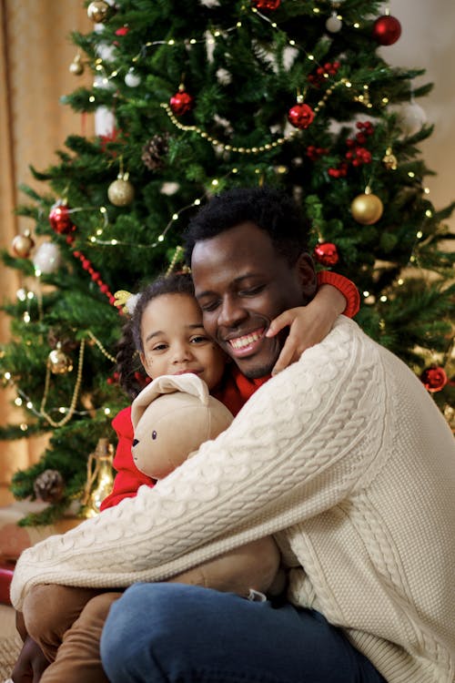 Dad and Daughter Hugging Each Other While Smiling