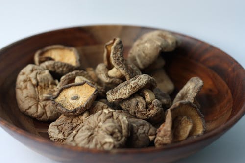 Dried Mushrooms on a Wooden Bowl