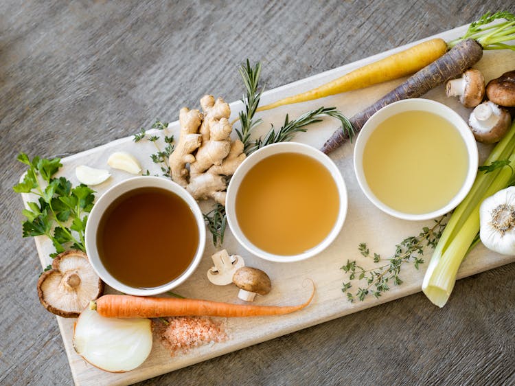 Bowls With Soup Over A Wooden Tray