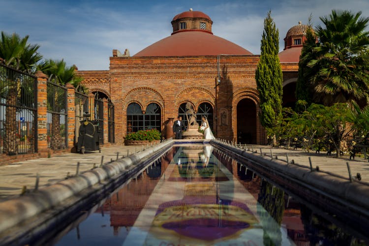 Couple Standing Near A Pool On Their Wedding Day