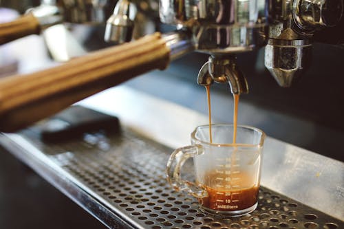 Free Professional coffee machine brewing coffee in glass Stock Photo