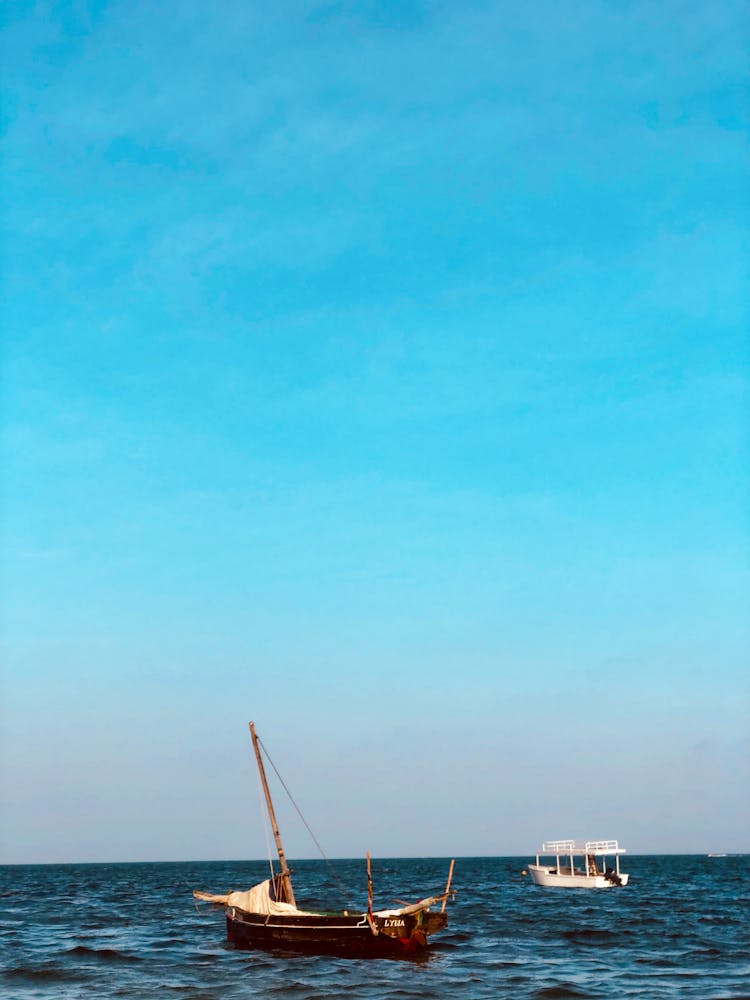 Boats Sailing On Sea Under Blue Sky