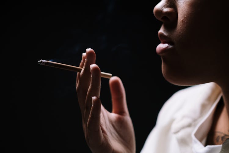 Close-Up Shot Of A Person Holding A Cigarette