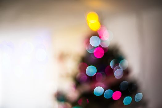 Colorful bokeh lights on a Christmas tree, creating a festive and dreamy atmosphere.