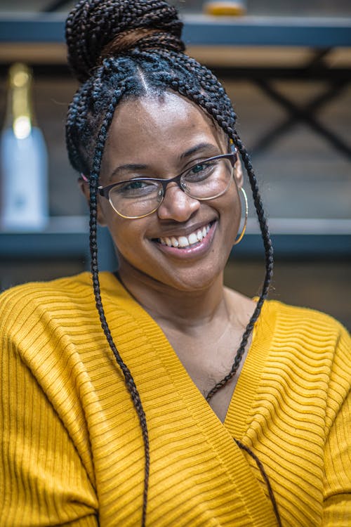 Close-Up Shot of a Woman in Yellow Top and with Eyeglasses Smiling