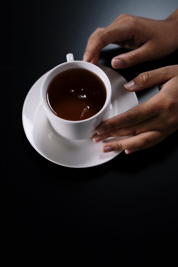 A Close-Up Shot Of A Person Holding A Cup Of Hot Chocolate