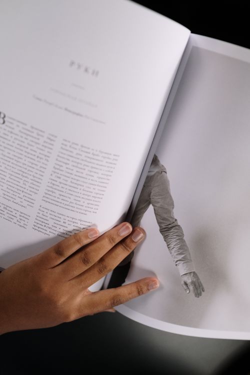 Picture Pags Hand Hand on Book Pages · Free Stock Photo