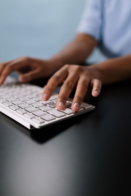 Hands typing on keyboard
